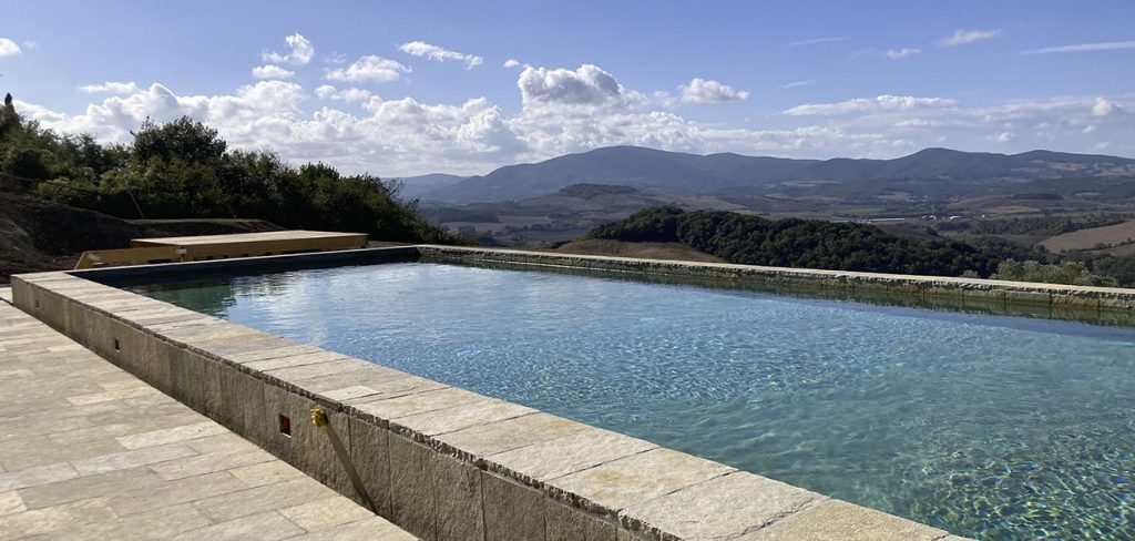 The pool edge and natural stone paving