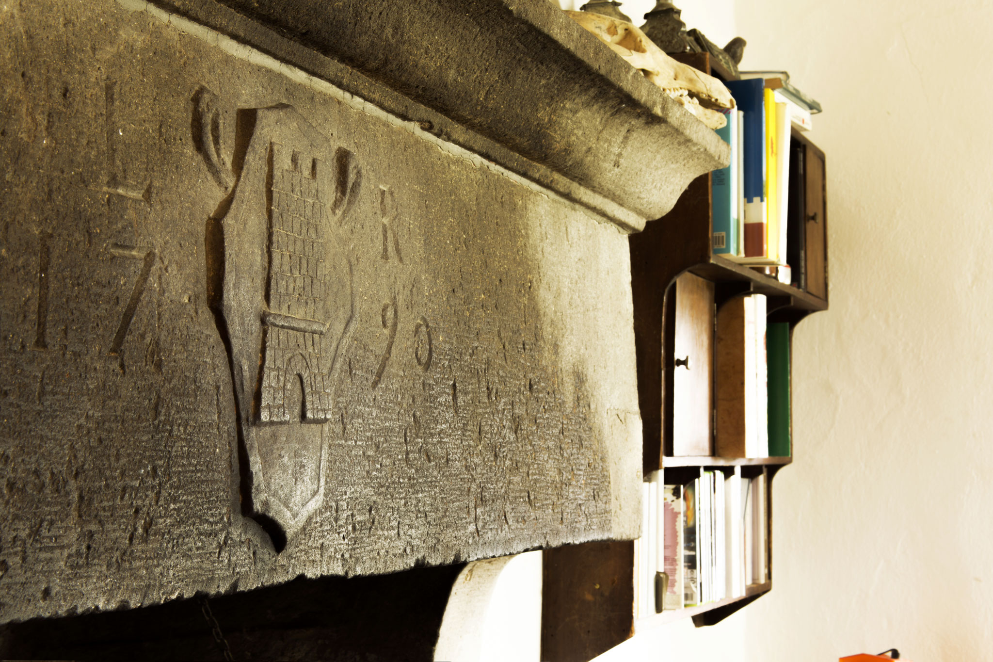 The fireplace of Casa dell'Arco bearing the emblem of La Rocchetta and the year 1790